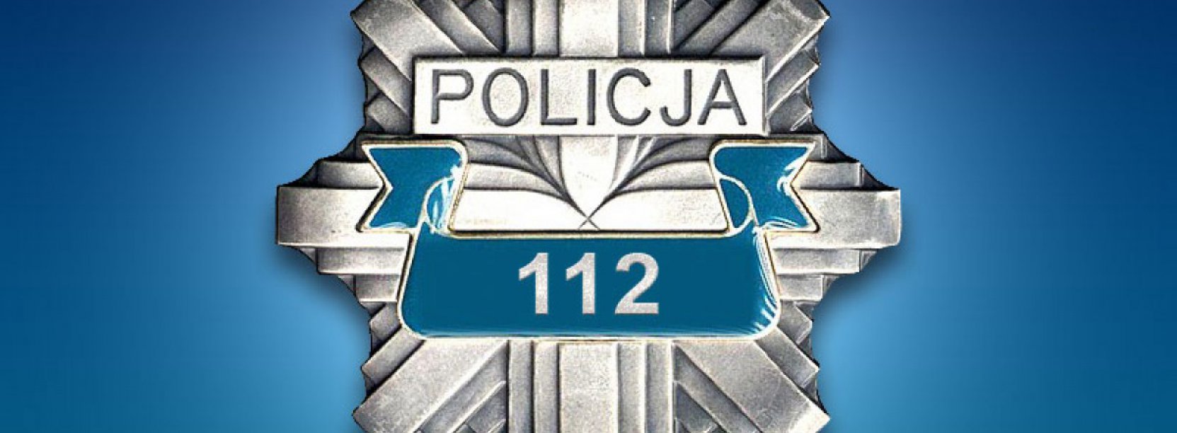 Odznaka z napisem Policja i numerem 112, na niebieskim tle
