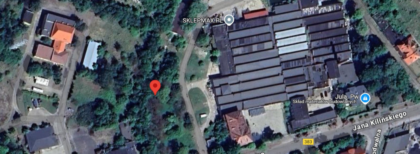 Fragment miasta z budynkami i dużą halą przmyłową z góry. Czerwonym punktem zaznaczono teren objęty przetargiem
