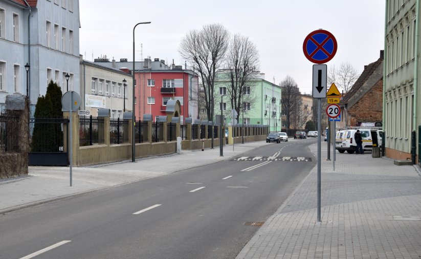 Wyremontowana droga, za nią duże kolorowe kamienice